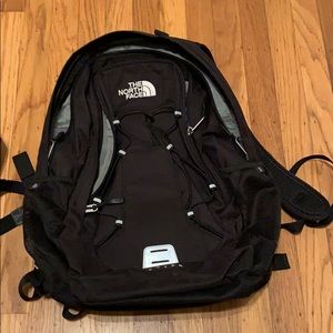 An all black north face jester backpack.